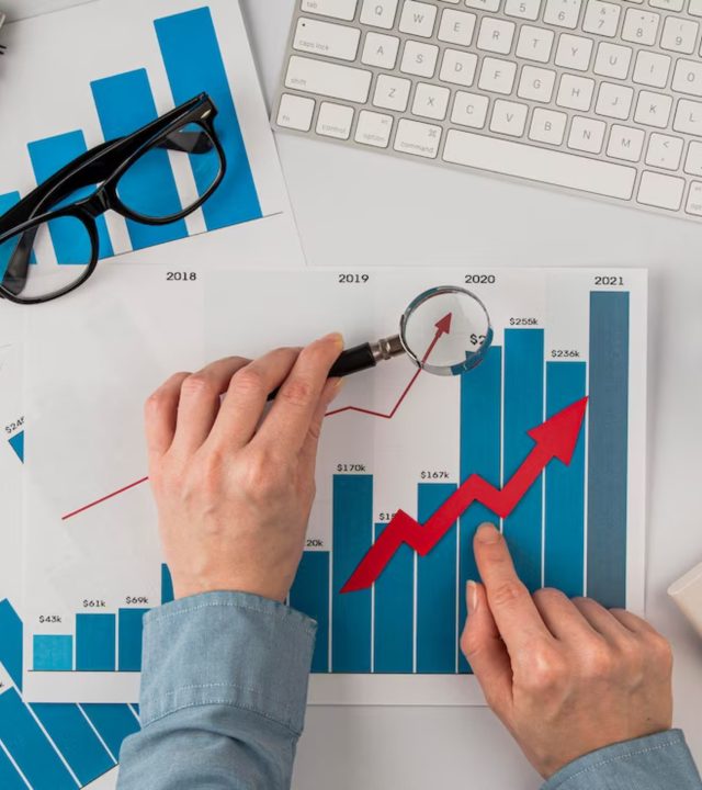 top-view-office-desk-with-growth-chart-hands-holding-magnifying-glass_23-2148780614 (1) top-view-office-desk-with-growth-chart-hands-holding-magnifying-glass_23-2148780614 (1)